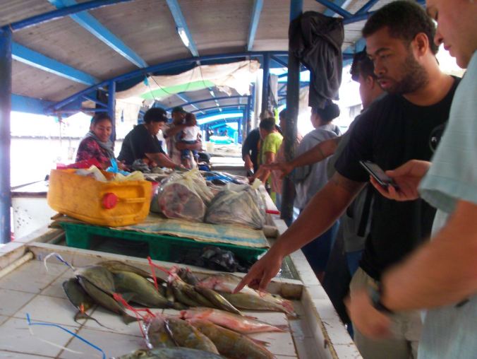 Active Learning: Watisoni Lalavanua (l) and Josh Drew (r) [tweeting!] at the Suva Fish Market, identifying species and talking about the best way to manage fisheries based in their life histories.